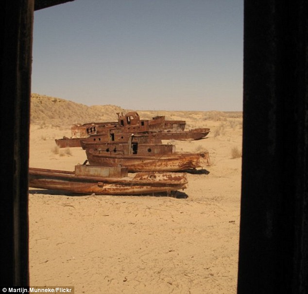 Ashes to ashes, rust to rust: perhaps these boats in a line signal where a pier used to lie. either way, the answer is lost to the sands